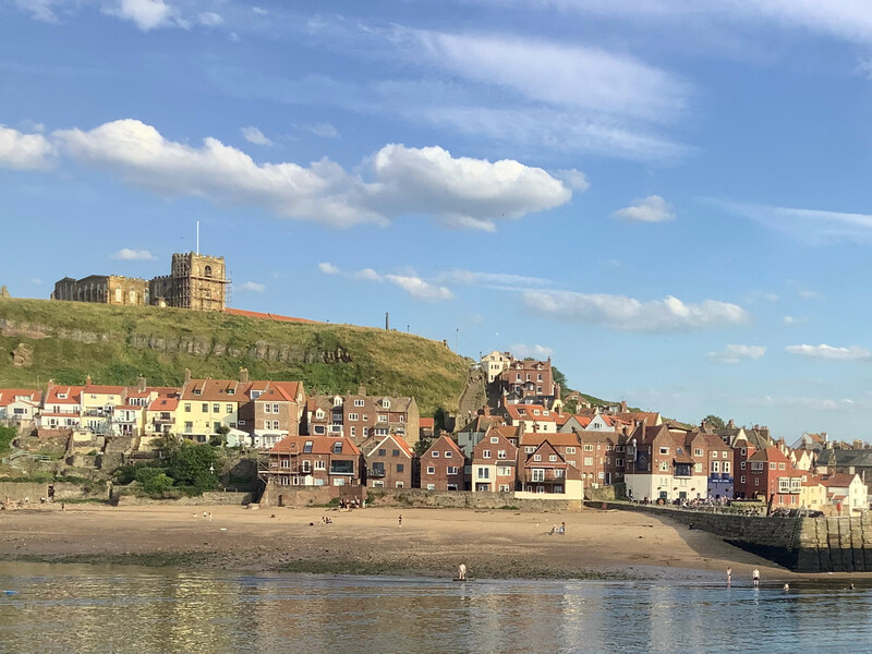 Photo: The "accumulation of sand and gravel" between East Pier (not shown) and Tate Hill Pier (lower right). Behind the strand, houses can be seen lining the lower part of the East Cliff, on top of which stands St Mary's Church with the churchyard to the left.