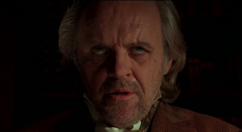 A disturbed-looking Anthony Hopkins as Van Helsing in Coppola's Bram Stoker's Dracula, rolling his eyes with lips parted, shadows playing across his face
