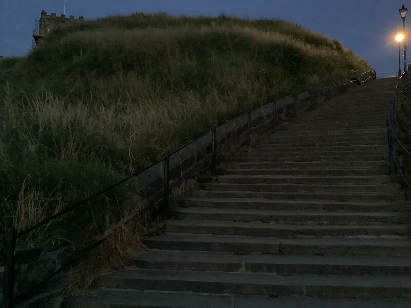 View up part of the 199 steps at night. Imagine that the lamplight on top is a gas light.